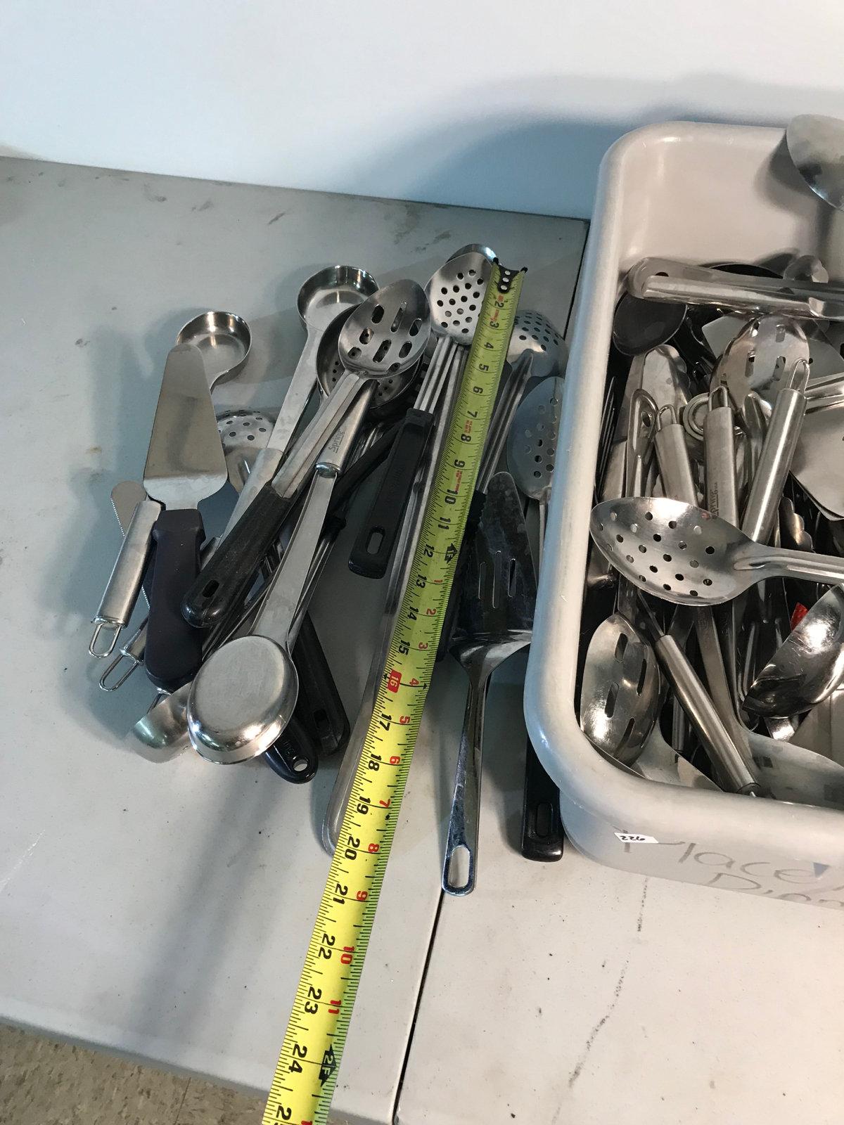 Large assortment of serving utensils, with bus tote