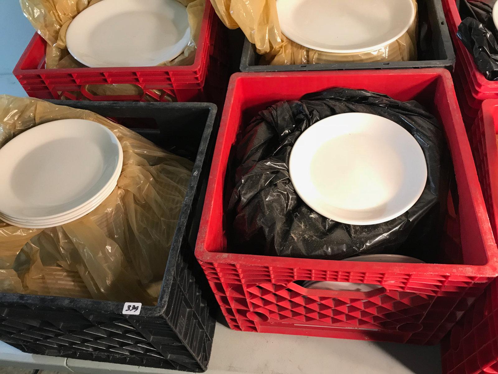 6 milk crates with various dishes, mostly dinner plates