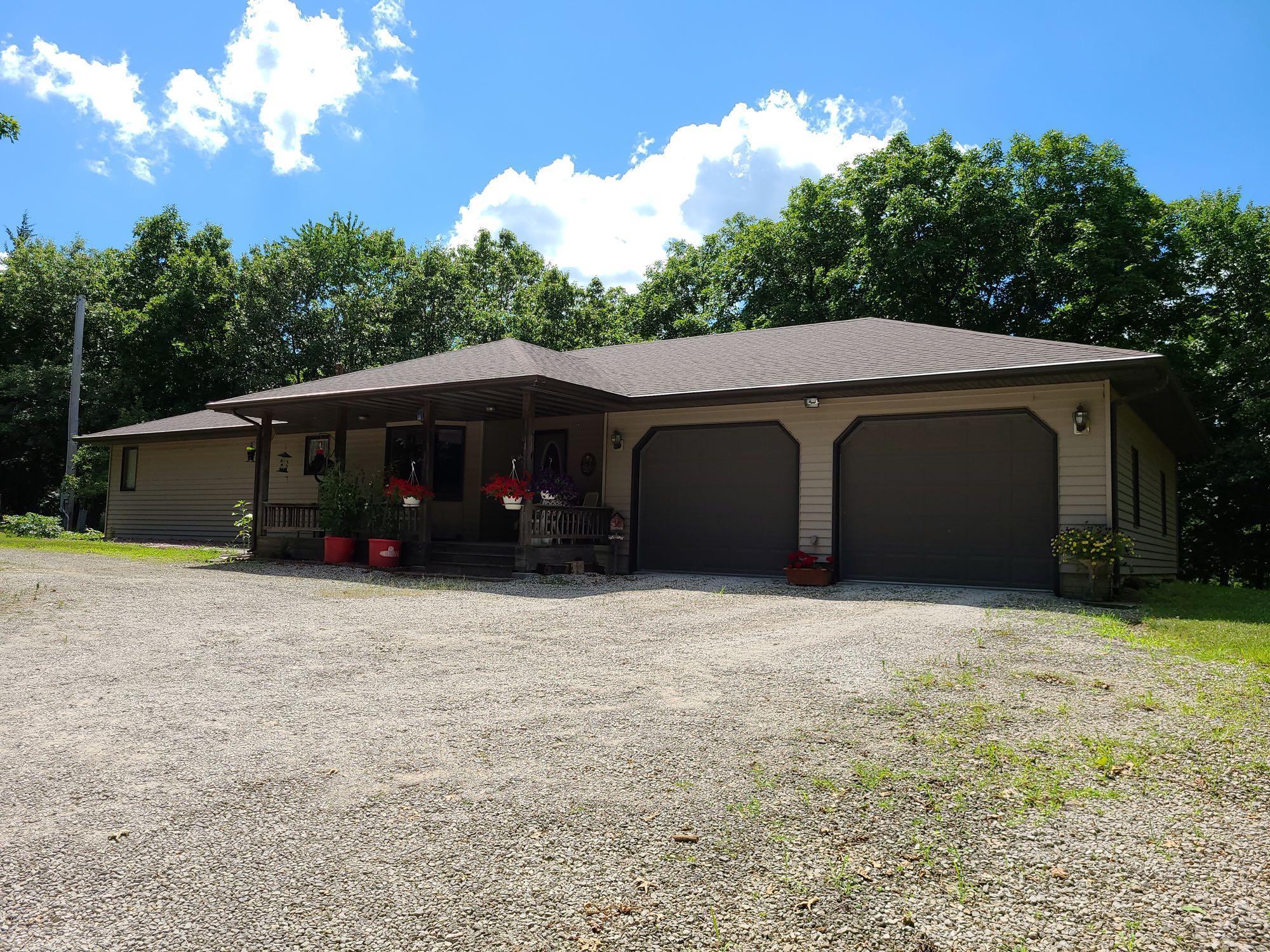 69.13 TAXABLE TIMBERED ACRES WITH NICE RANCH HOME AND LARGE SHOP AFTON, IOWA