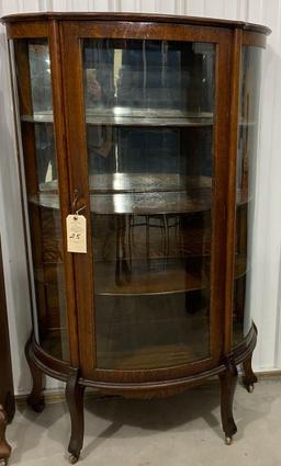 Antique curved glass curio cabinet on casters