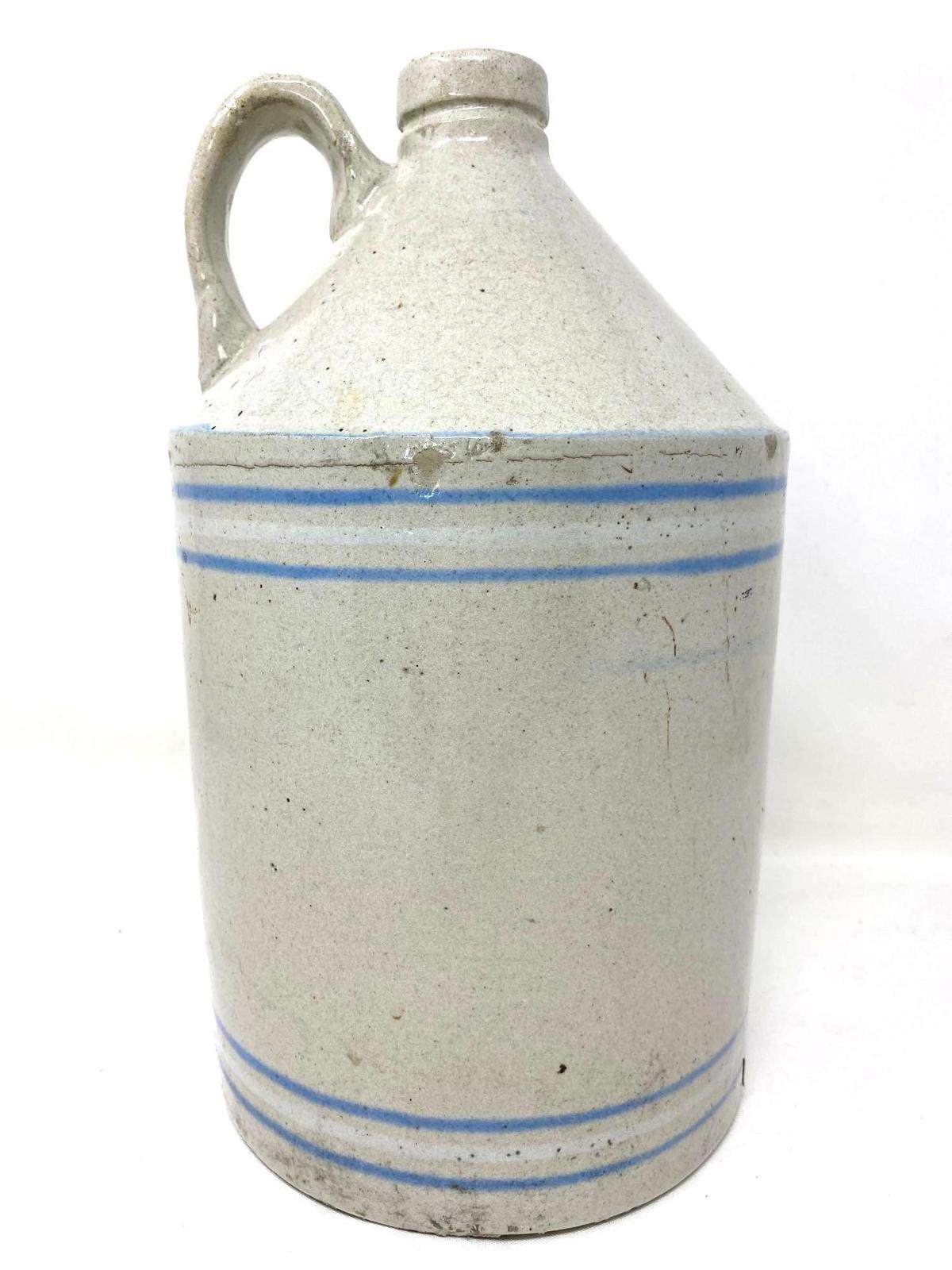 Antique white crock jug with blue and white lines