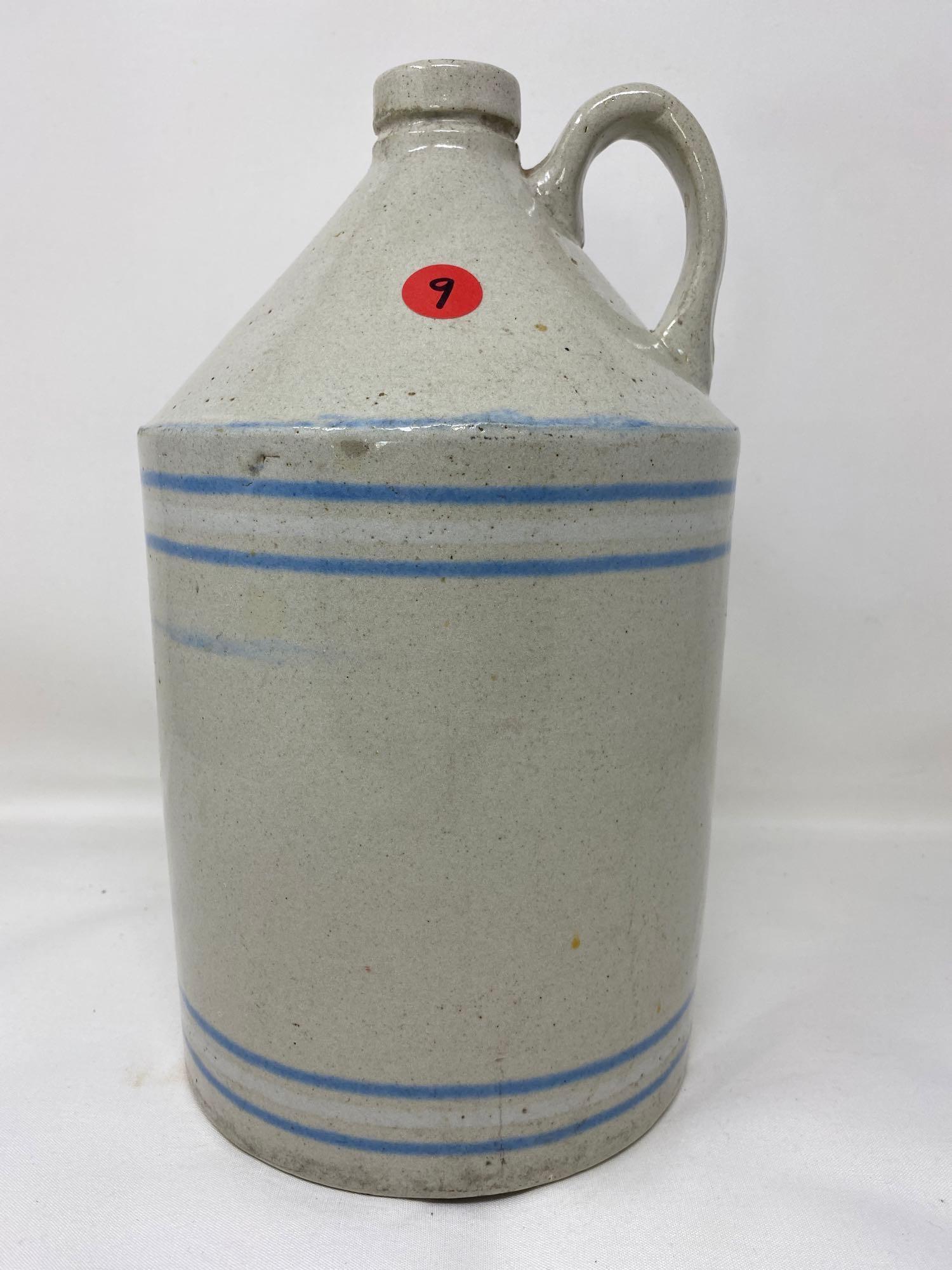 Antique white crock jug with blue and white lines