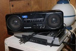 Metal Shelf with contents including lamps, radios, and cassette player