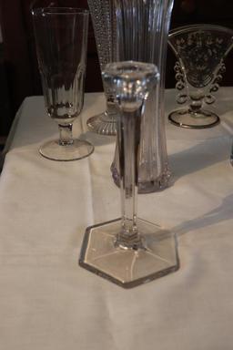Large quantity of clear glass vases and candle holders
