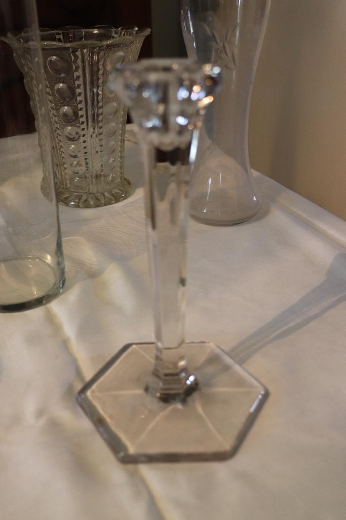 Large quantity of clear glass vases and candle holders