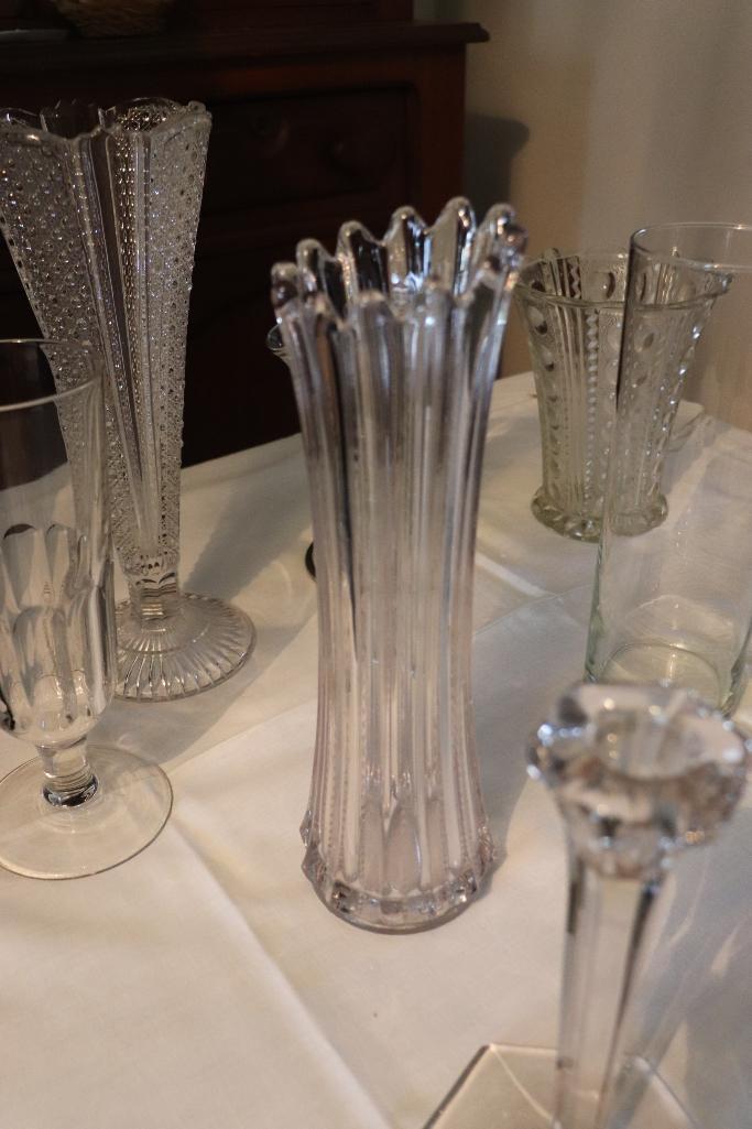 Large quantity of clear glass vases and candle holders