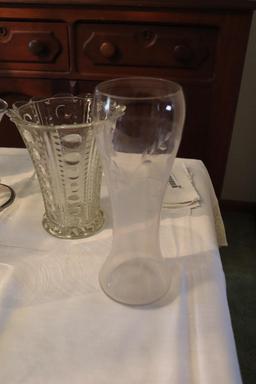 Large quantity of clear glass vases and candle holders