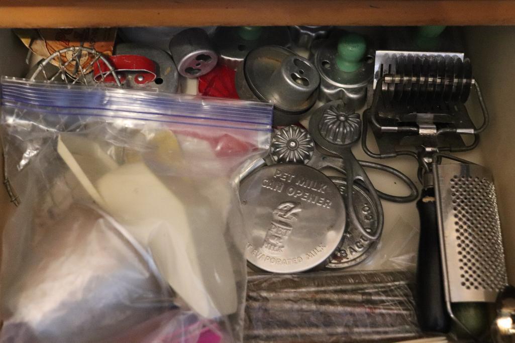 Contents of drawer including vintage kitchen utensils