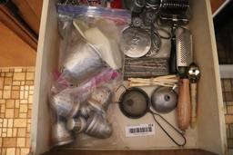 Contents of drawer including vintage kitchen utensils