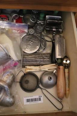 Contents of drawer including vintage kitchen utensils