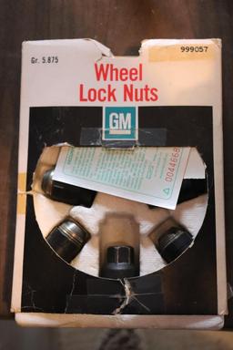 Quantity of Cadillac wheel lug nuts, seatbelt extender, high intensity headlight bulbs