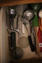 Contents of drawer including kitchen utensils