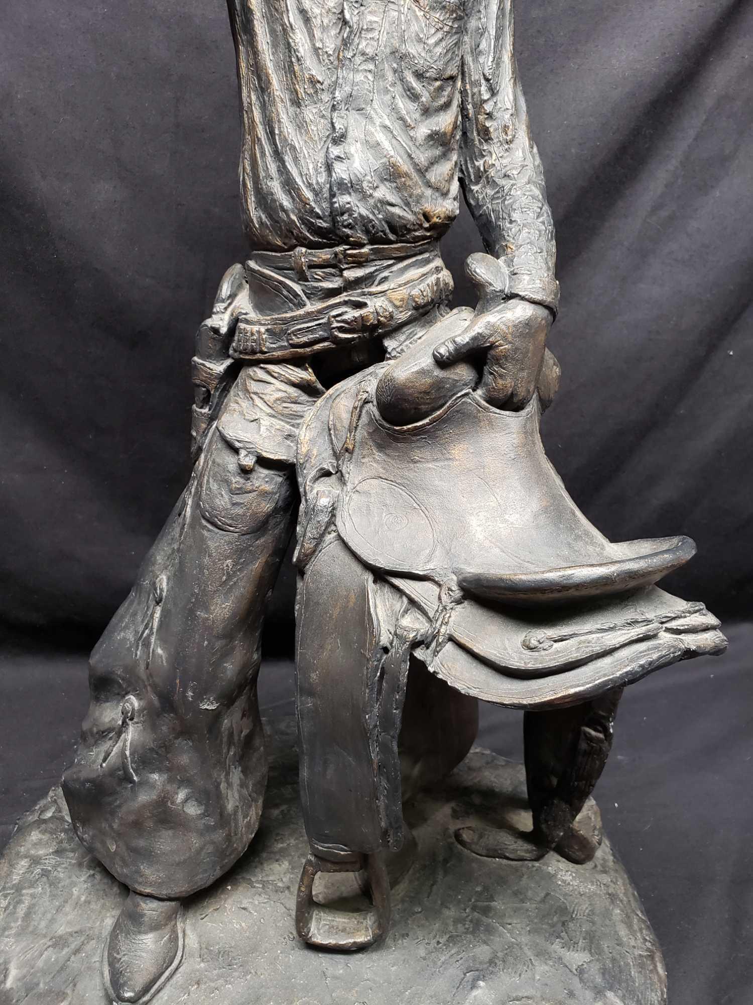 Statue says 1972 Michael Garman. Cowboy with saddle