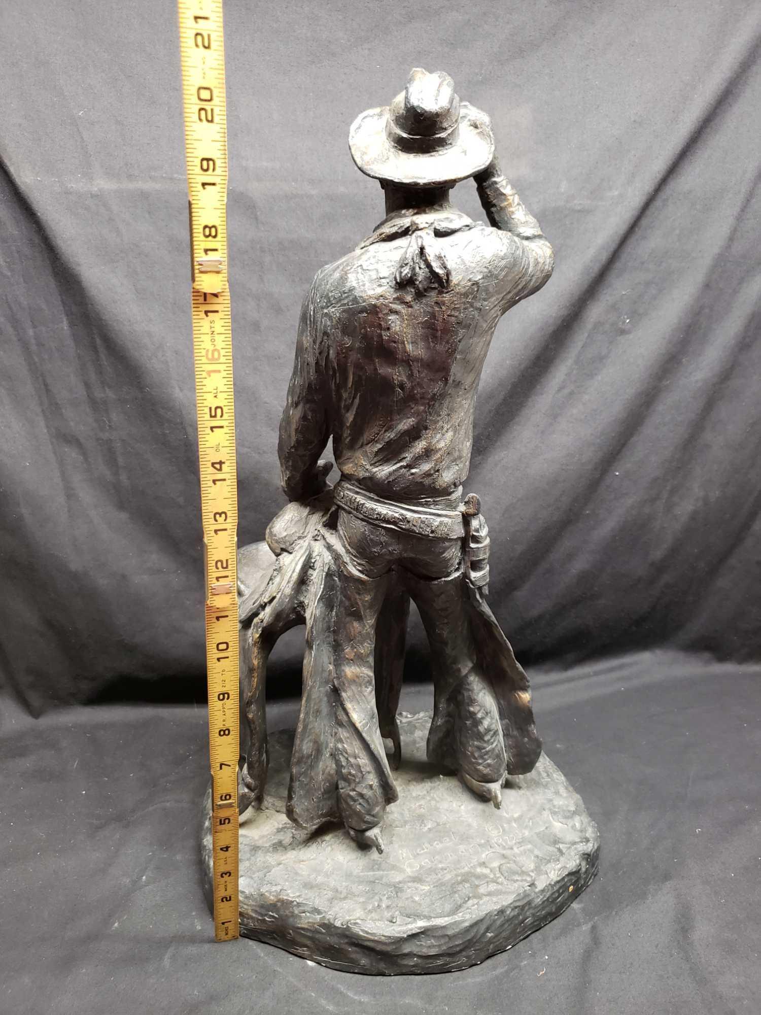 Statue says 1972 Michael Garman. Cowboy with saddle