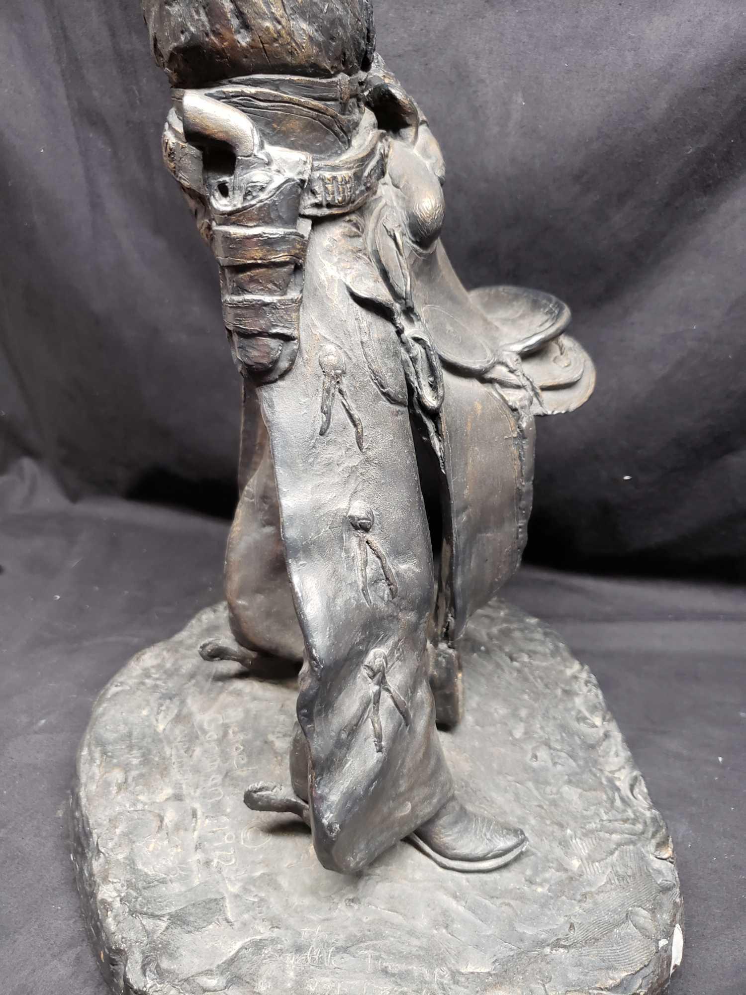 Statue says 1972 Michael Garman. Cowboy with saddle