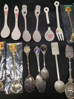 Collector spoons. Korea. Saipan. Canada. Silver and gold look. Some porcelain look spoons and fork.
