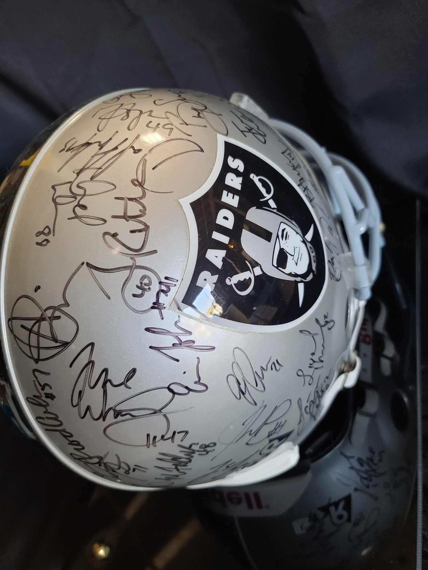 Helmet plaque says Raiders Team signed Hof