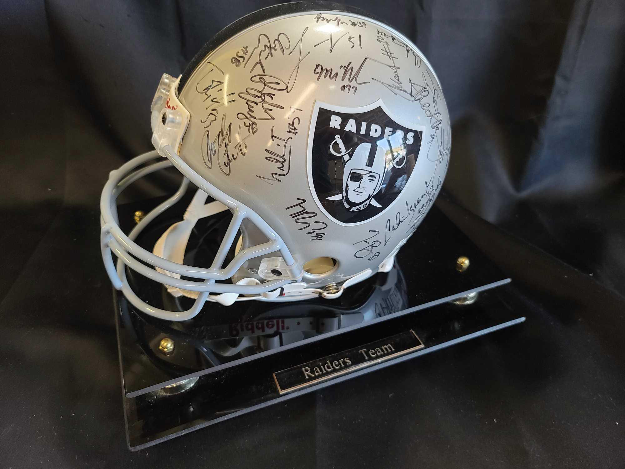 Helmet plaque says Raiders Team signed Hof