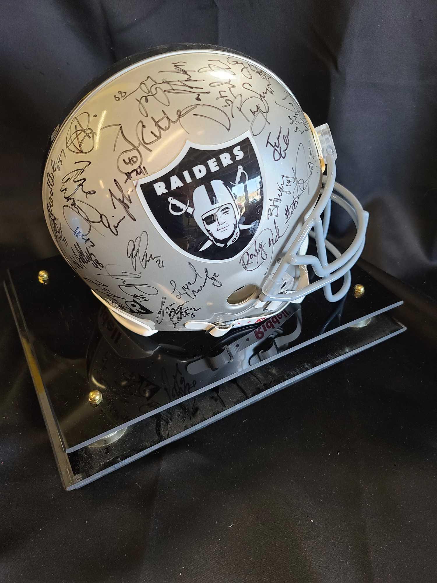 Helmet plaque says Raiders Team signed Hof