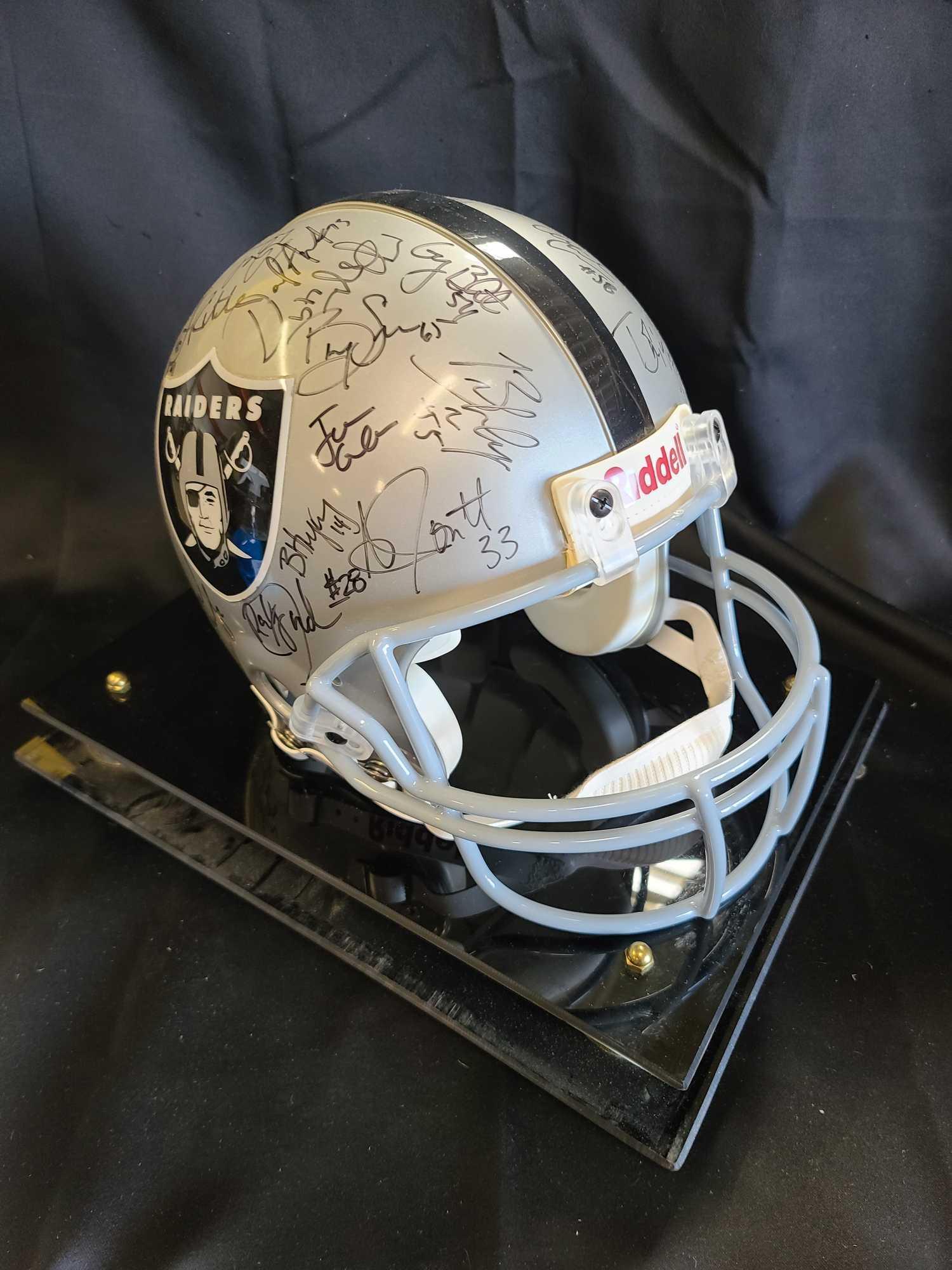 Helmet plaque says Raiders Team signed Hof