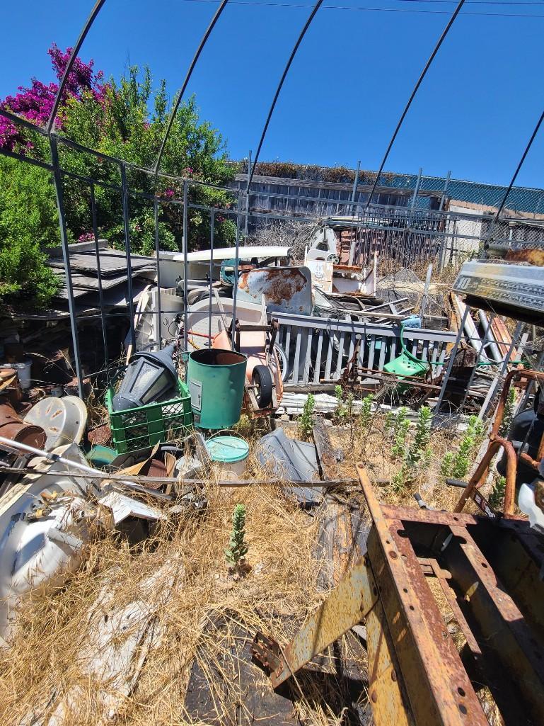 Backyard- Rusty Gold - Fencing lumber beams ladders trashcans rototiller pallet racking