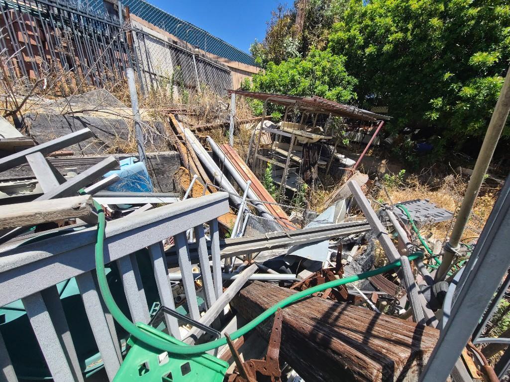 Backyard- Rusty Gold - Fencing lumber beams ladders trashcans rototiller pallet racking
