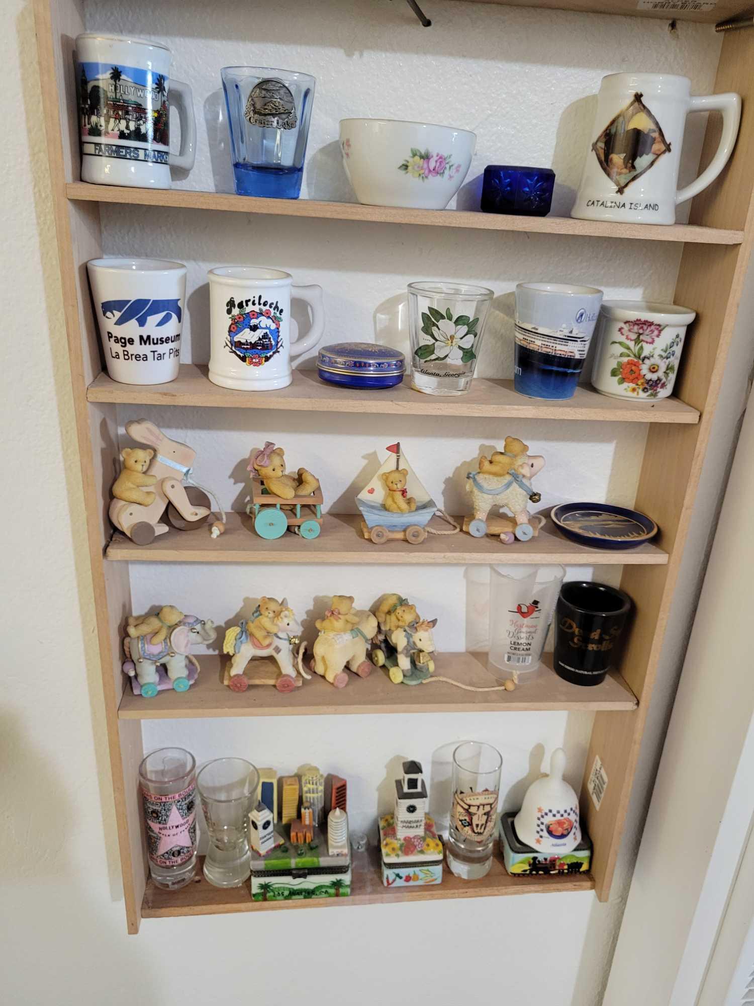 Contents on shelf including Bird and Owl figurines cherished teddies coffee mugs and more