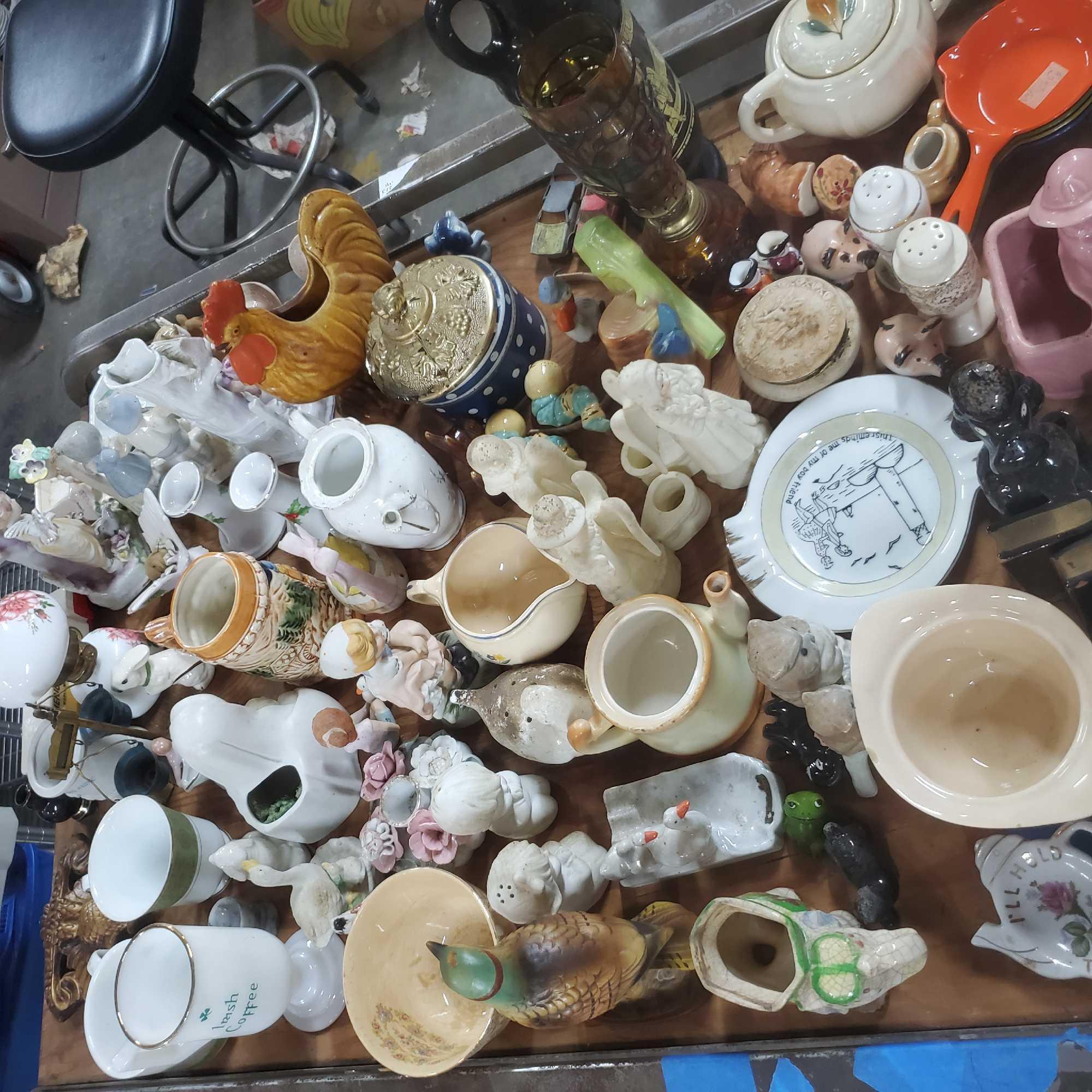 Shelf of vintage ceramic figures oil lamps salt and pepper shakers Goodwill Location