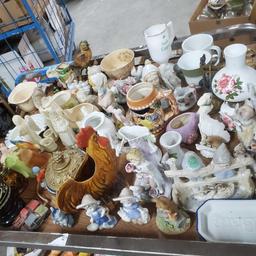 Shelf of vintage ceramic figures oil lamps salt and pepper shakers Goodwill Location