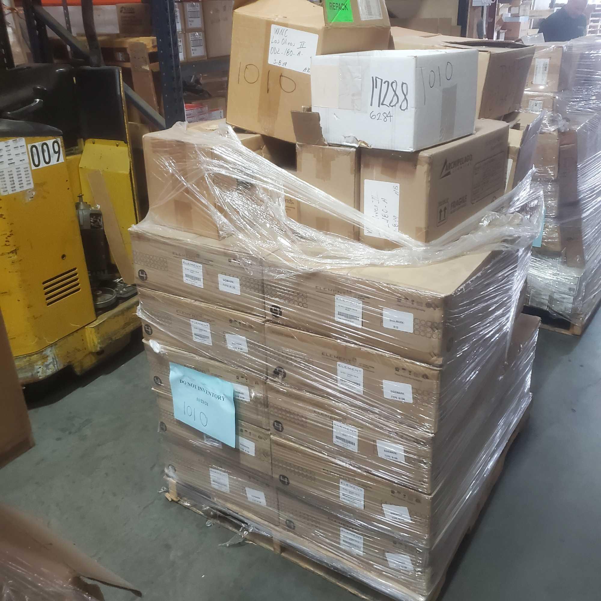 Pallet of tech recessed lighting bulbs and hardware