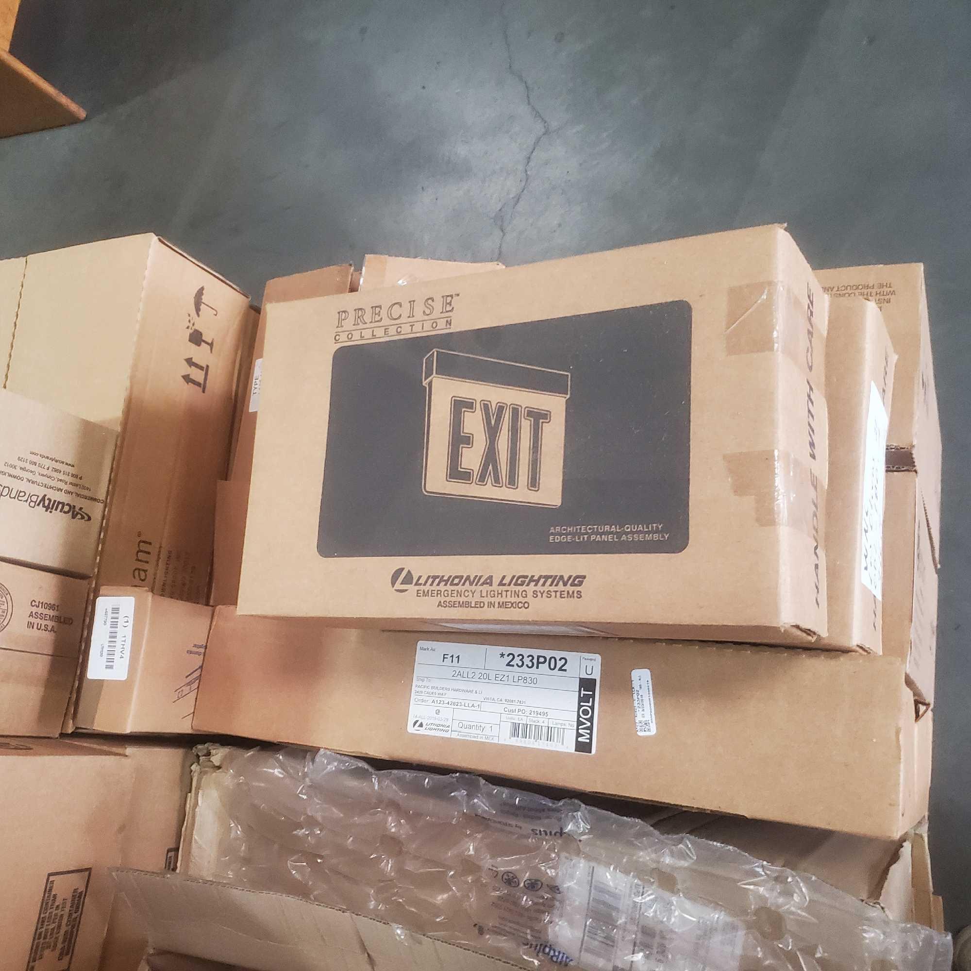 Pallet of architectural downlighting and exit sings