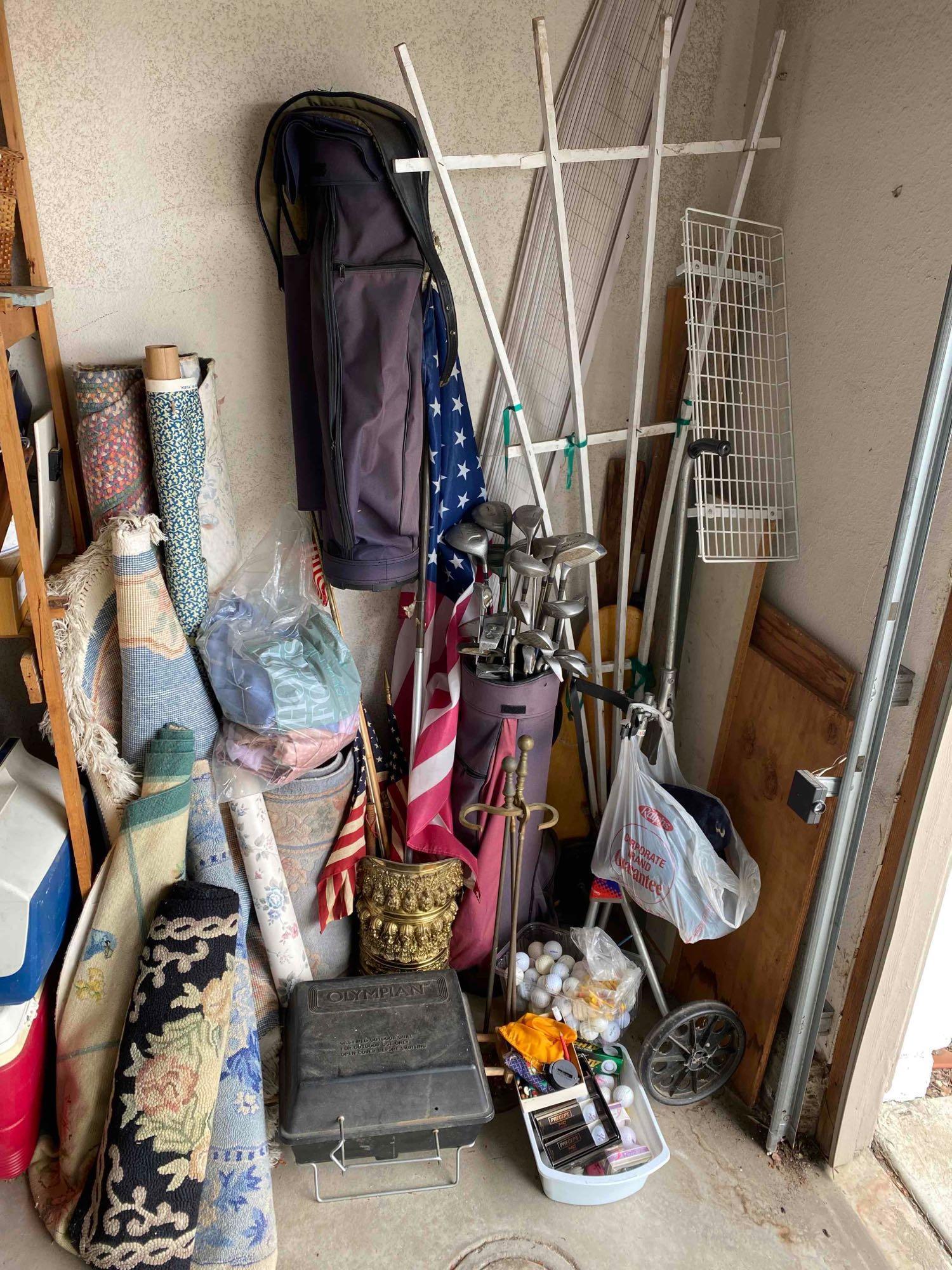 Corner of garage stuff random items, rugs, fabric bolt, golf, bbq, flag, etc.