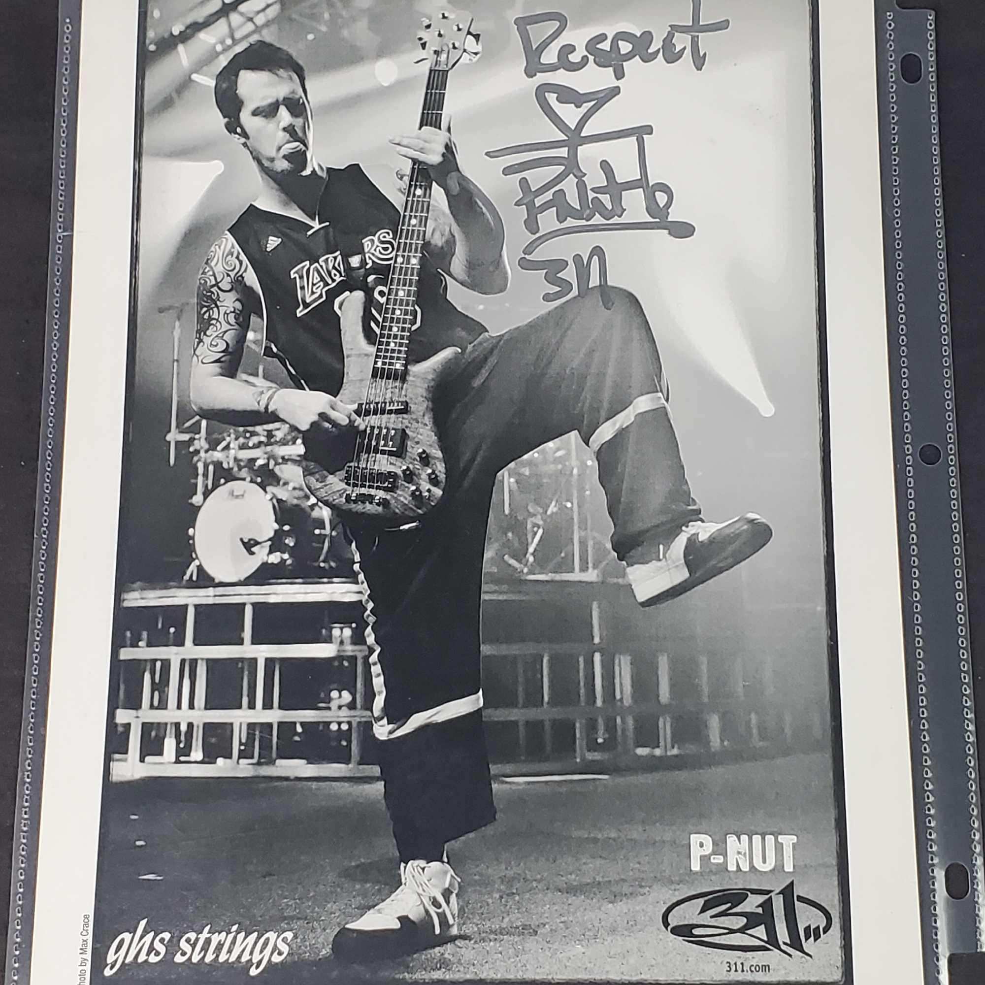 Black and white photograph of 311 guitar player P-Nut with signature