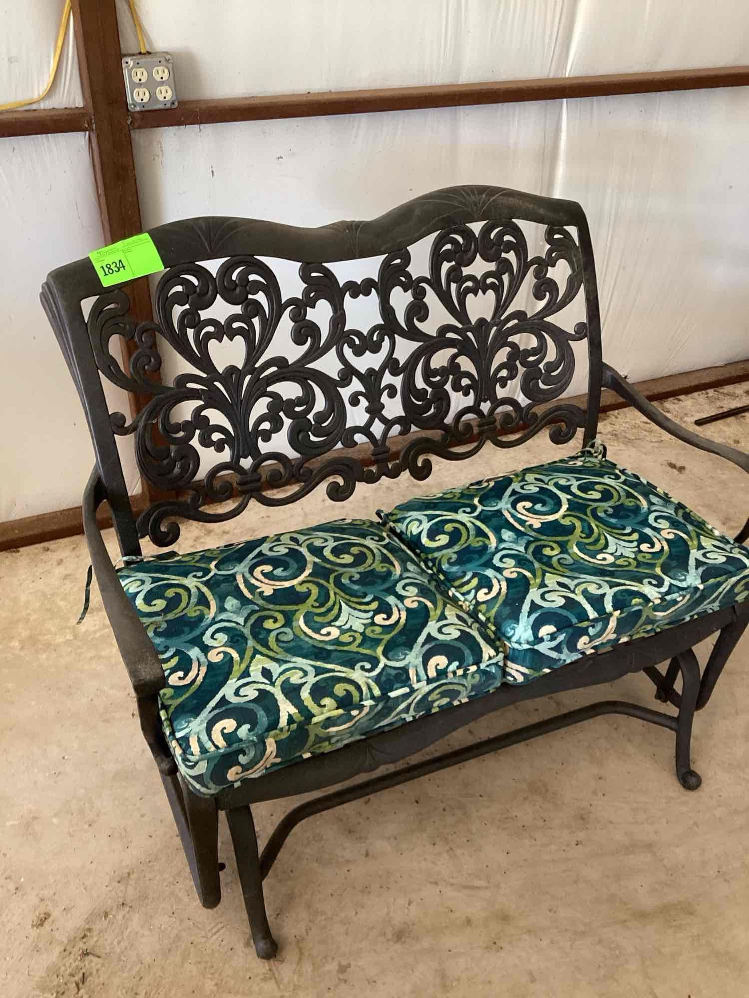 Wrought iron glider bench. Two cushions are included but it is...comfortable with or without the