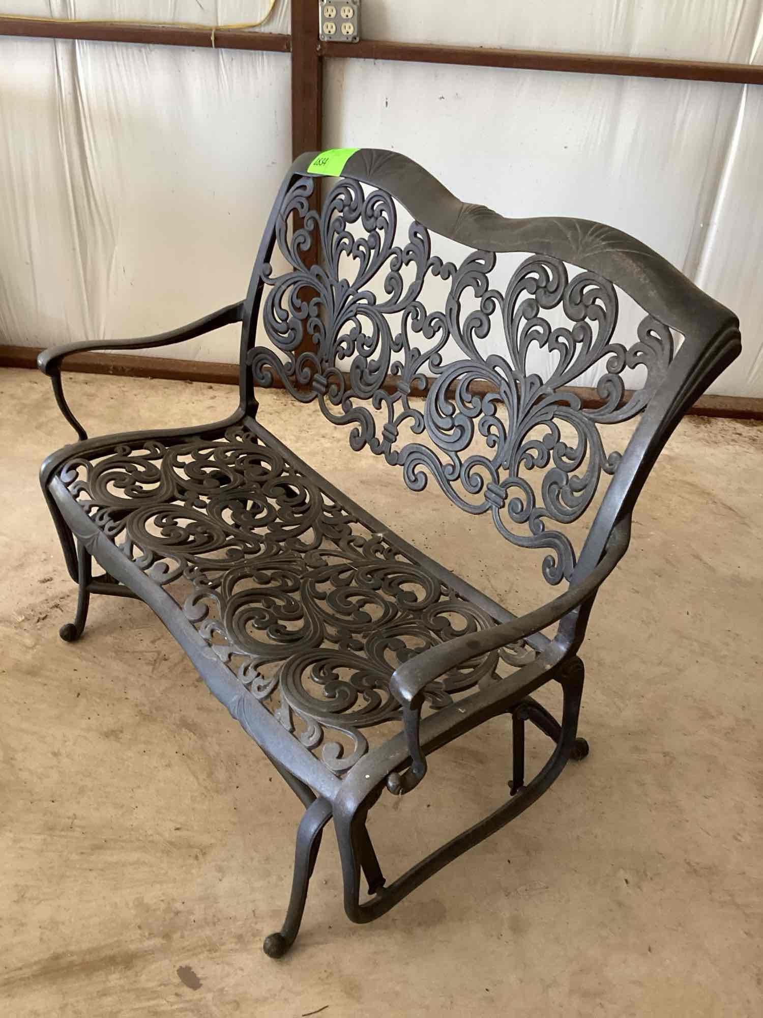 Wrought iron glider bench. Two cushions are included but it is...comfortable with or without the