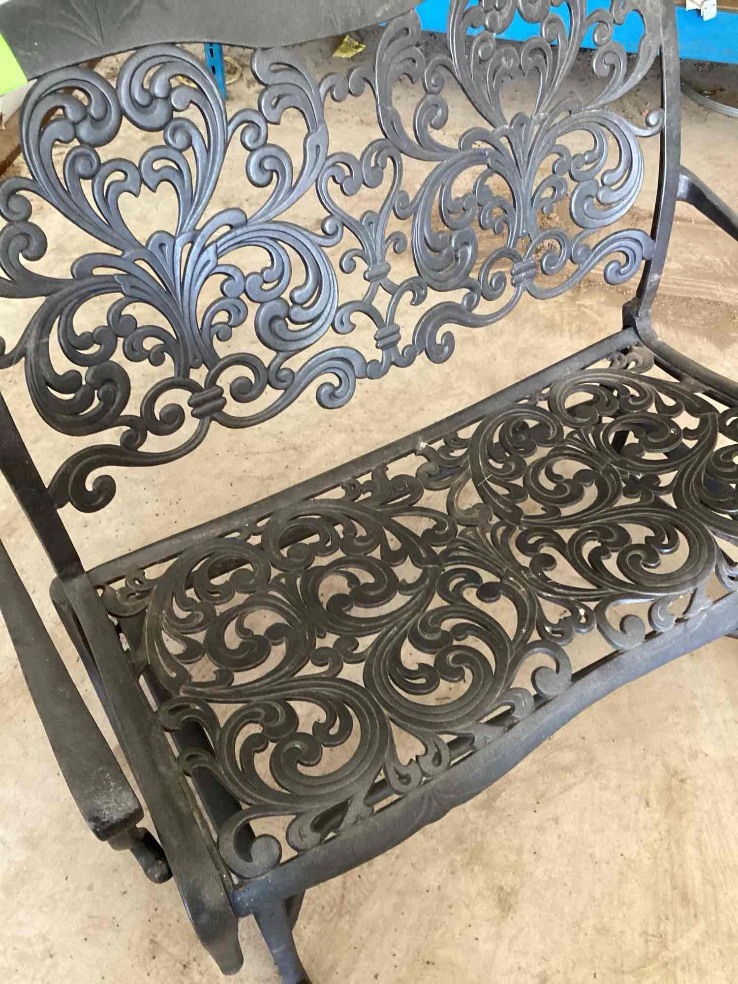 Wrought iron glider bench. Two cushions are included but it is...comfortable with or without the