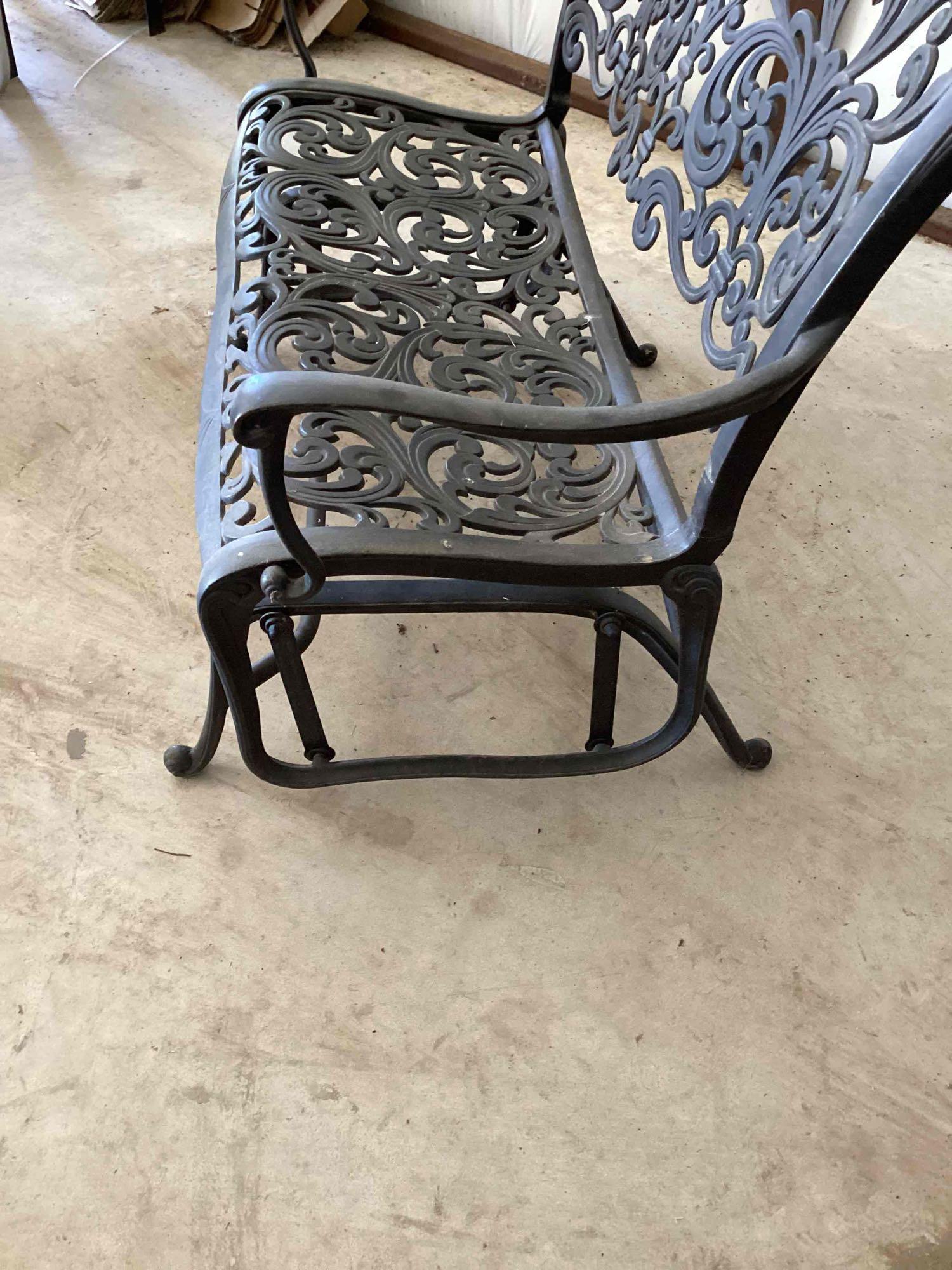 Wrought iron glider bench. Two cushions are included but it is...comfortable with or without the