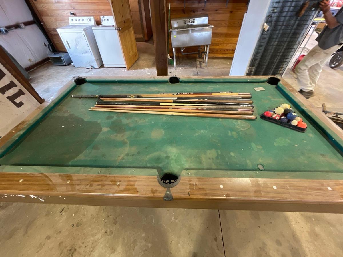 pool table, sticks balls, tips and bushes