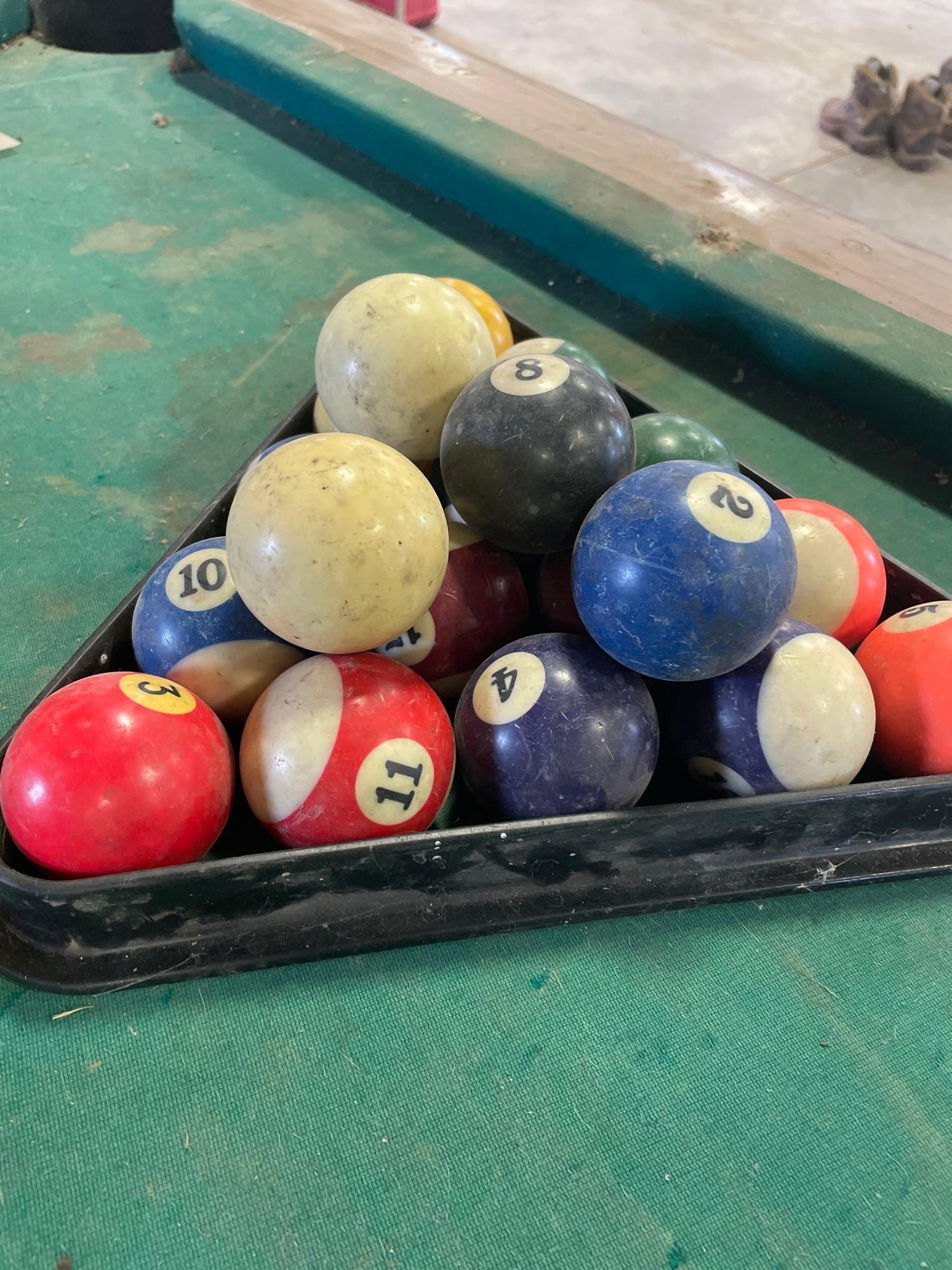 pool table, sticks balls, tips and bushes