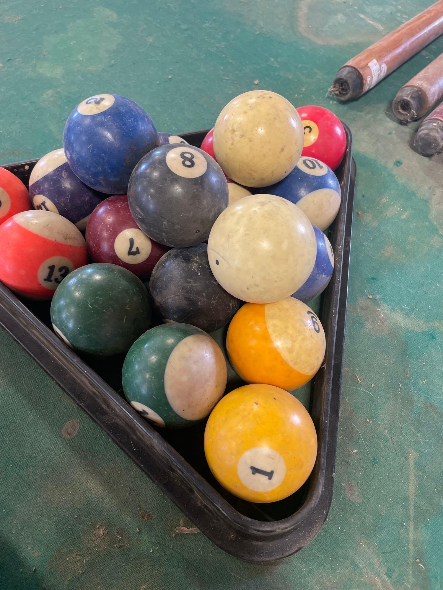 pool table, sticks balls, tips and bushes