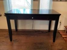 wooden black desk with outlet