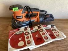 Ridgid corded sander and packages of discs