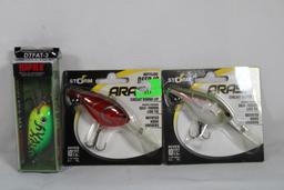 Two Storm Arashi and one Rapala fishing lures. New in packages.