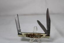Buck Model 373 small stockman with 2.5 inch main blade. Brass bolsters with simulated stag scales.