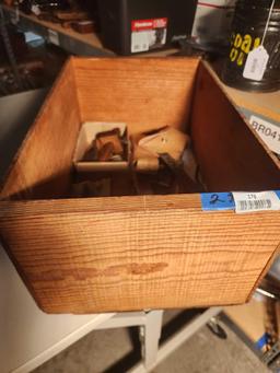 Wooden crate with miscellaneous tools and two leather hatchet covers. Used.