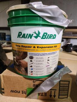 Box and bucket of home irrigation tubing and parts. New.