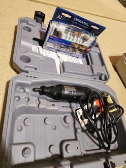 Dremel tool with accessories in plastic case.