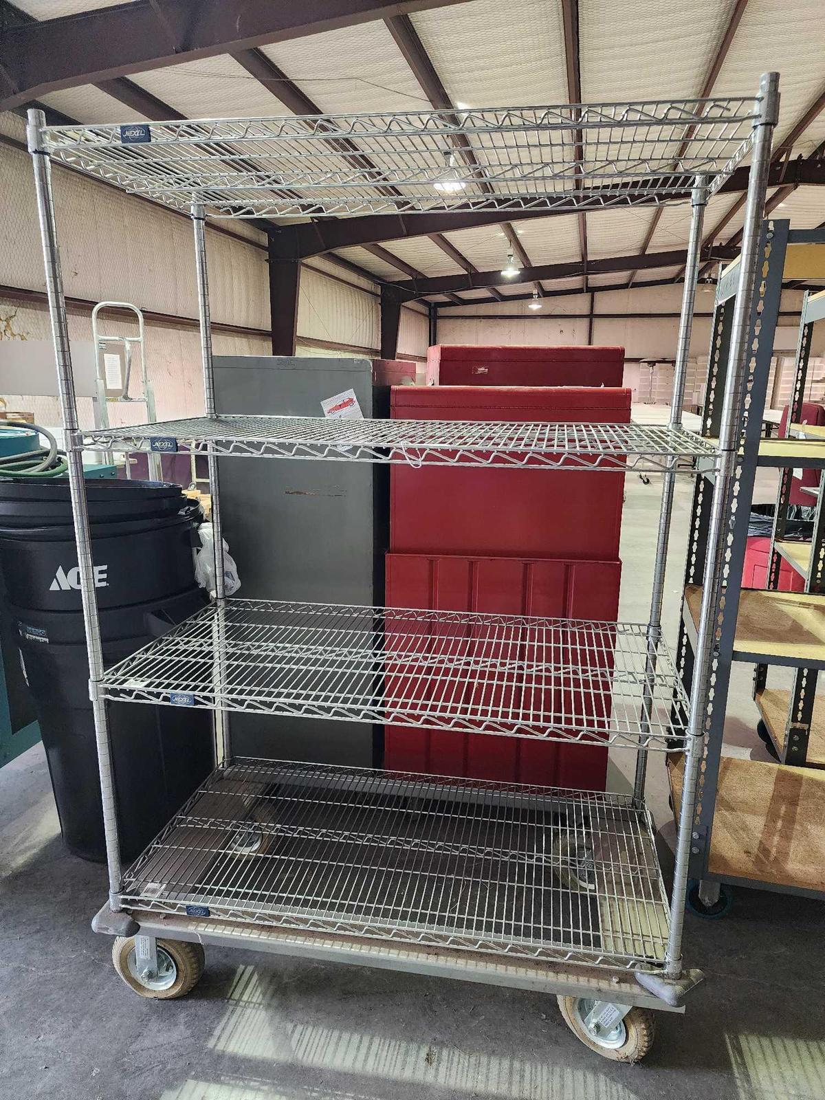 All steel 4 shelf roll storage. Used, in good condition. 48" x 24" x 72". Tires are air filled.