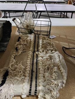 Fringed carpet bag and one old metal milk delivery tray and five 6 oz glass Grapette soda bottles.