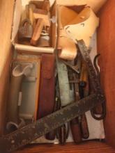 Wooden crate with miscellaneous tools and two leather hatchet covers. Used.